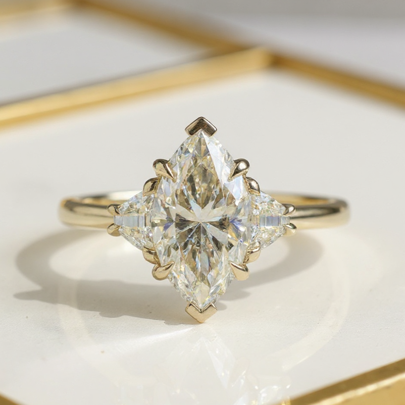 Enhancethecenterstonetolooklike__Thiselegantlab-growndiamondringcaptureslightfromeveryangle_creatingadazzlingdisplayofbrillianceandfireTheshapeofthediamond_withits58expertly_1 2.5Ct Marquise Cut Moissanite Three Stone Engagement Ring with Trapezoid Side Stones in 14k Gold - Image 1